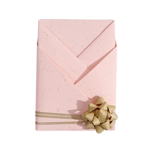 Pink white kraft gift wrapping paper with gold foil speckles and a glittery gold bow