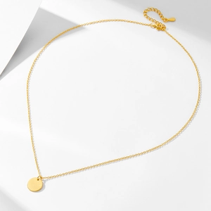 Minimalist gold plated sterling silver necklace with round pendant on white background