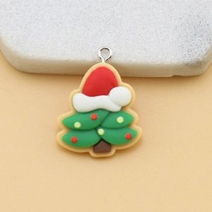 Detailed close-up of a green resin Christmas tree pendant with red hat and metal loop