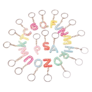 Sparkly alphabet keychain set in colorful resin with glitter finish on white background