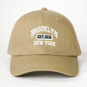 Detailed white embroidery of Brooklyn New York on a khaki cotton baseball cap
