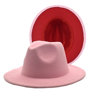 Detail view of pink and red two-tone wool felt fedora hat with a wide brim and jazz style