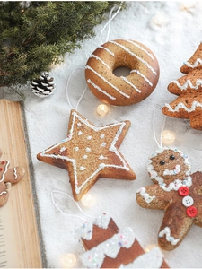 Close-up of glittery Christmas tree ornaments with faux frosting and colorful sprinkles