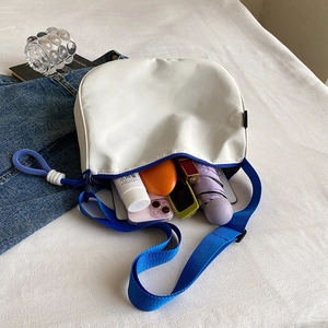 Blue and white canvas crossbody bag for women with spacious interior storage space