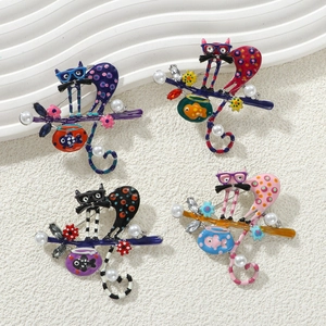 Detail of four colorful alloy cat brooches with enamel, rhinestones and faux pearls
