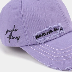Vintage purple washed cotton baseball cap with distressed details and side embroidery