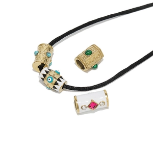 Golden Evil Eye hexagonal cylinder beads on a black cord necklace with colorful crystals