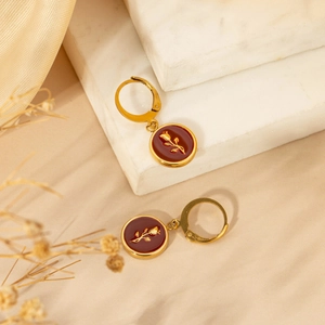 Golden rose floral drop earrings on marble tray with vintage 18K gold plated steel finish