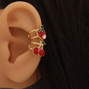 Cute strawberry and cherry ear cuffs set with red enamel and golden finish on model