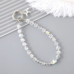 Macro shot of iridescent crystal beaded phone strap with metal balloon dog pendant