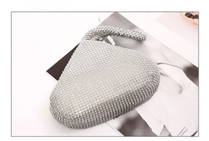 Macro bottom view of silver rhinestone evening clutch bag with sparkling diamond surface