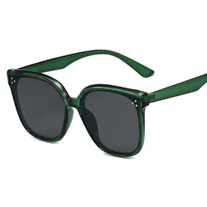 Fashionable oversized square sunglasses with transparent green frames and dark grey lenses