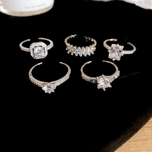 Detailed view of 5-piece silver heart ring set with zircon on black velvet display