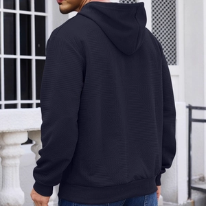 Navy men's hoodie with geometric knit texture and ribbed hem shown from the back view