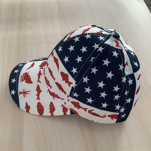 American flag baseball cap featuring stars and red fish print on light wood background