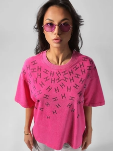 Close-up of rose pink washed cotton T-shirt featuring interlocking black H letter pattern