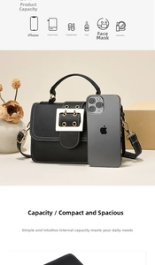 Detail view of black PU leather crossbody bag showing large gold buckle and storage capacity