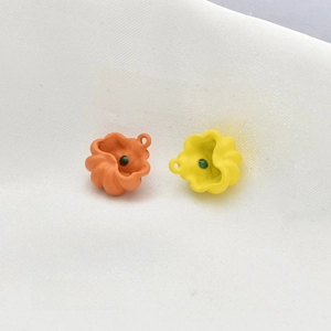 Back view of orange and yellow pumpkin alloy pendants with small green bead inlay