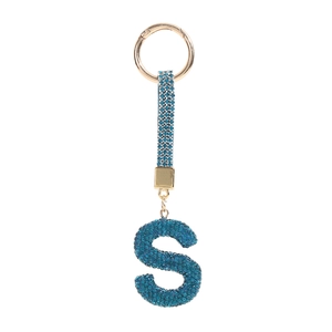 Detailed view of luxury gold keychain with blue rhinestone encrusted letter S charm