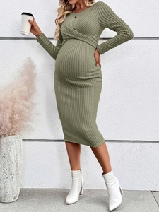 Olive green knit maternity dress with cross-neckline and slim-fit long sleeves