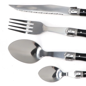 Laguiole style stainless steel cutlery set with black handles and bee emblem on white background