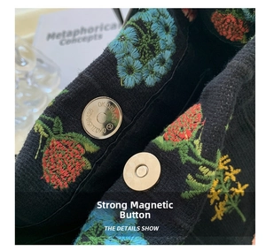 Detailed close-up of a high-power magnetic buckle on a floral embroidery canvas tote bag