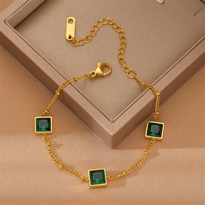 Golden titanium steel bracelet with three emerald square gems and roman numerals detail