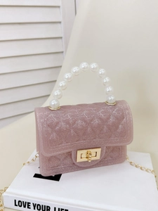 Pink glitter jelly handbag with pearl handle and quilted texture on white background