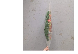 Thickness detail of Christmas wreath with red bows and berries in protective packaging