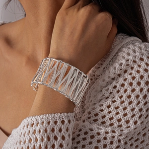 Detailed view of silver wide-band geometric cuff bracelet with parallel wire texture
