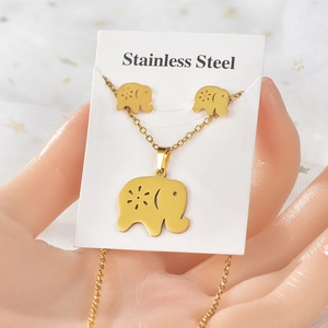 Macro view of gold stainless steel elephant jewelry set featuring hollowed-out patterns