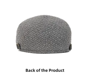 Rear view of grey knit beret featuring thick textured fabric and bronze metal buckle