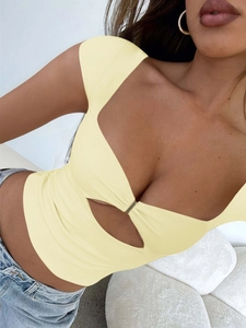 Close-up of yellow slim fit knit top featuring deep V-neck and hollow-out chest detail