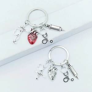 Detailed macro of nurse keychain featuring medical heart, syringe and stethoscope charms