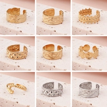 Set of nine adjustable open rings with wave, mesh, and chain textures in gold and silver