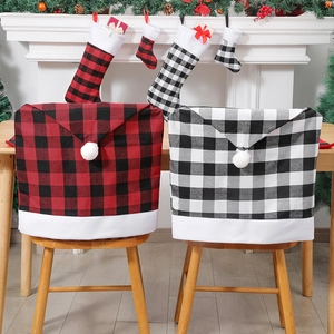Christmas red and black plaid chair covers with matching stockings in a cozy home setting