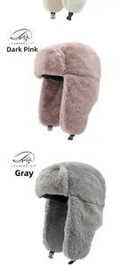 Detail of warm faux fur trapper hats in dusty pink and grey with adjustable chin straps