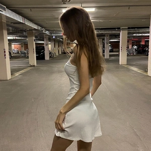 Sleeveless white bodycon mini dress with textured fabric shown in a side view profile