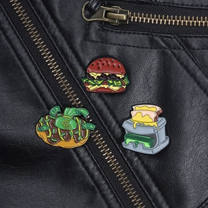 Detail of cartoon food enamel pins featuring burgers and dollars on a black leather jacket