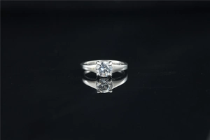 Detailed view of round moissanite solitaire ring with classic four-prong setting