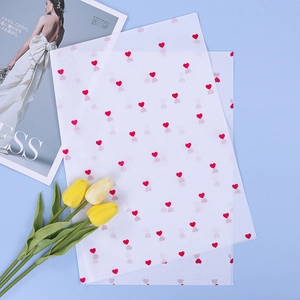 Translucent wrapping paper with red heart patterns for floral bouquets on blue background
