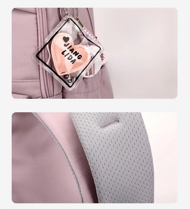 Detail of lavender backpack with breathable mesh straps and a pink heart-shaped charm
