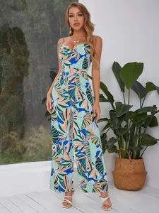 Detail of tropical print jumpsuit with spaghetti straps and vibrant leaf pattern