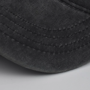 Detailed close-up of a vintage dark grey washed cotton military cap with triple stitching