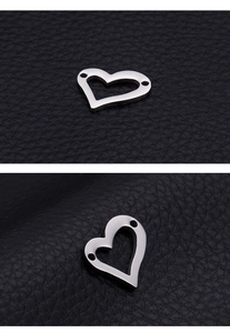 Detail of silver heart-shaped hollow connector with two holes for DIY jewelry making