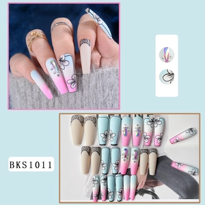 Long trapezoid press-on nails with floral patterns, rhinestones and color gradient