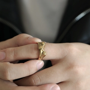 Close-up of a vintage golden frog-shaped ring made of high-quality titanium steel metal