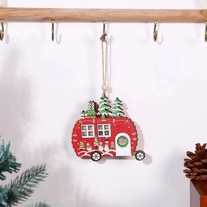 Detail of wooden RV Christmas ornament with LED lights and painted snowman hanging on a hook