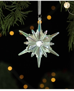 Close-up of iridescent acrylic snowflake ornament with faceted crystal on Christmas tree