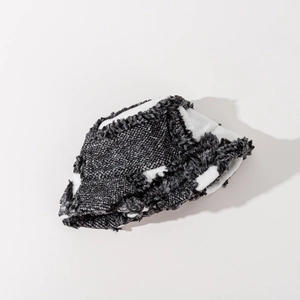 Detailed macro view showing the fuzzy texture and fringe weave of the plaid bucket hat